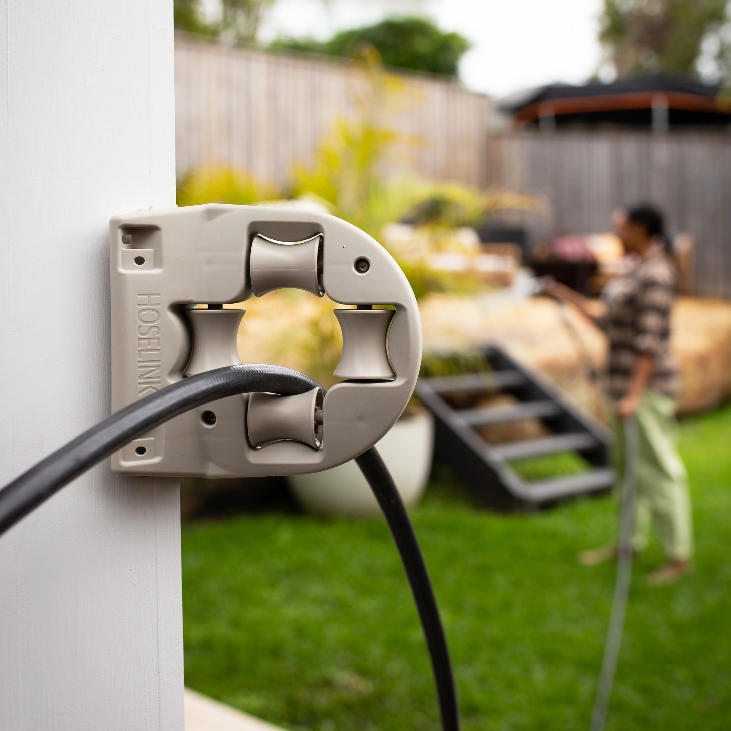 Protect your garden hose and make it easier to pull around walls