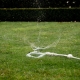 Water lawns and garden areas with the Hoselink Rotating 3-Arm Sprinkler and Metal Base. Water pressure drives the three arms to rotate and distribute spray around the sprinkler