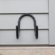 Store a loose garden hose neatly off the ground with the Hoselink Stainless Steel Hose Hanger. The wall-mounted curved support holds coiled hose securely and provides a durable