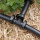 Branch a 13mm irrigation main line in two directions with the Hoselink 13mm Tee. The barbed T-shaped fitting joins three lengths of compatible poly pipe and is useful for dividing a system across separate garden beds or rows. Secure each connection with the specified ratchet clamps and avoid sharp pipe bends near the joint. This listing is for an individual tee and does not include pipe or clamps.
